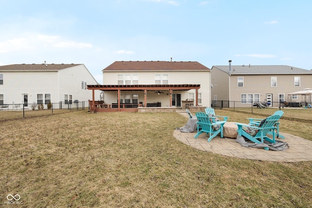 rear view of house featuring a fenced backyard, a lawn, and a patio