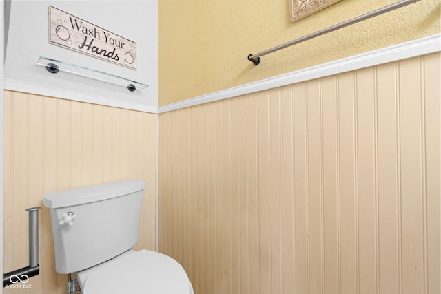 bathroom with wainscoting and toilet