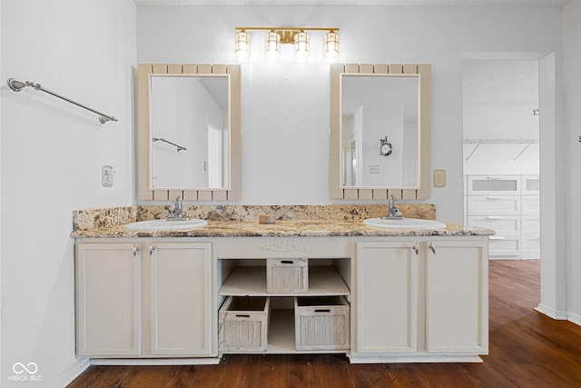 full bathroom with a sink, wood finished floors, and double vanity