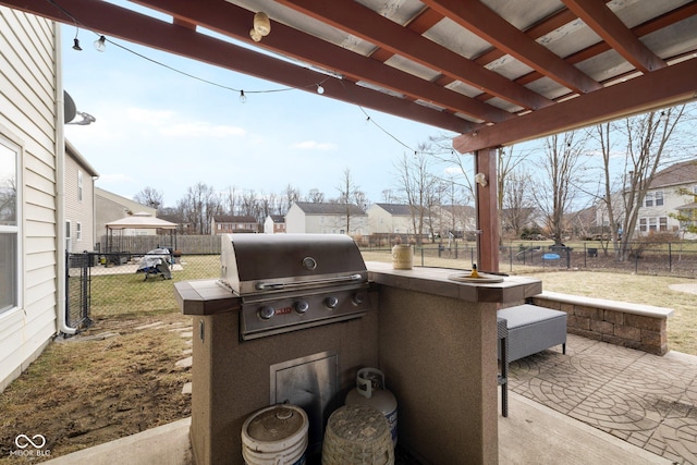 view of patio featuring grilling area, exterior kitchen, and a fenced backyard