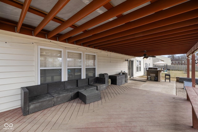 exterior space featuring an outdoor living space, fence, and ceiling fan