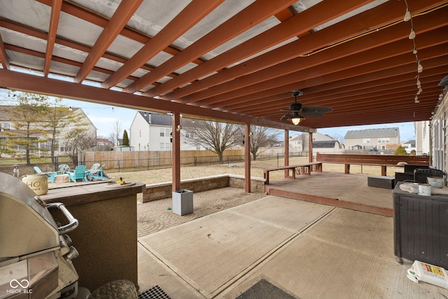 view of patio featuring ceiling fan, a grill, and a fenced backyard