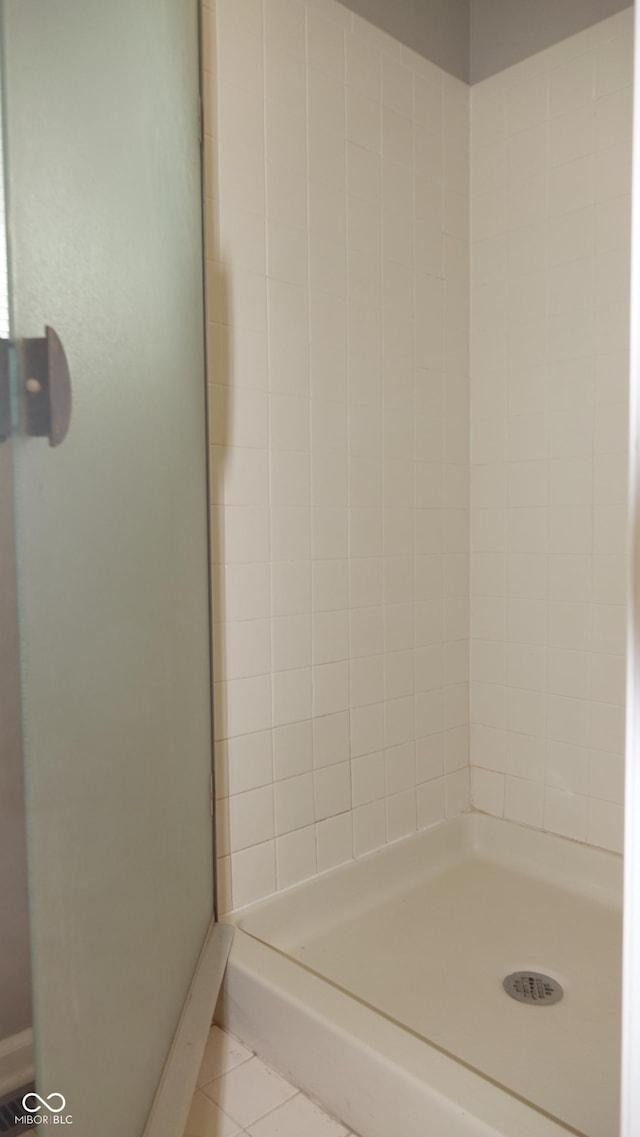 full bath with a shower stall and tile patterned floors