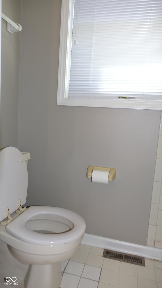 bathroom with baseboards, visible vents, and toilet