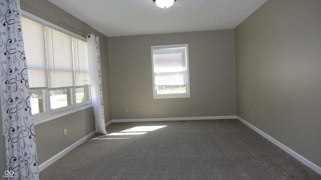 spare room with carpet floors and baseboards