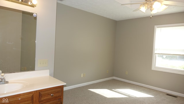 bathroom featuring a textured ceiling, vanity, visible vents, and baseboards