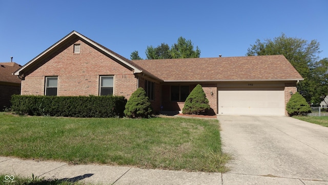 single story home featuring brick siding, a front lawn, and an attached garage