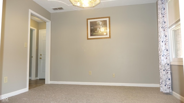 unfurnished bedroom with carpet, visible vents, and baseboards