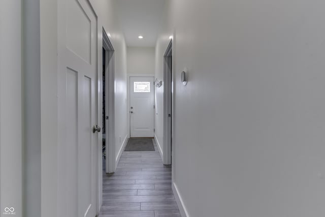 hallway with dark wood-style floors and baseboards