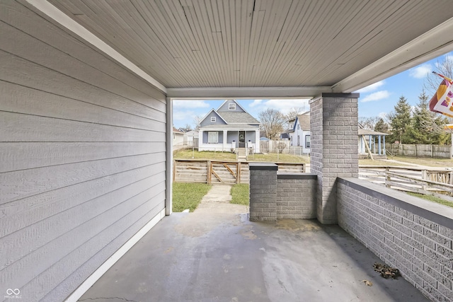 view of patio with covered porch and fence