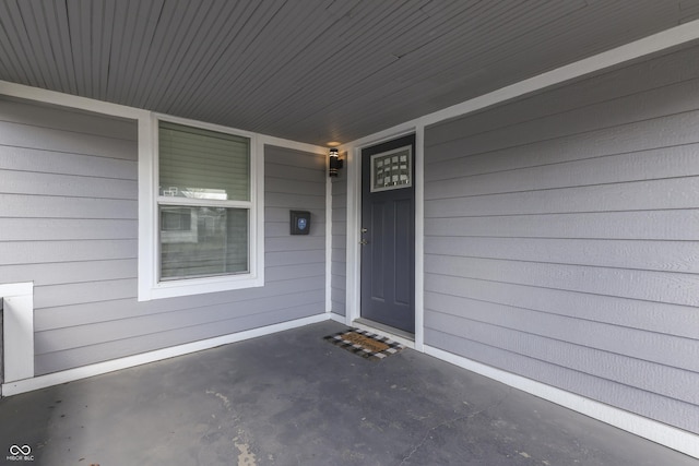 view of exterior entry with covered porch