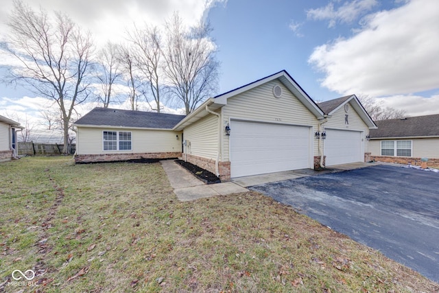 single story home featuring a garage, brick siding, a front yard, and aphalt driveway