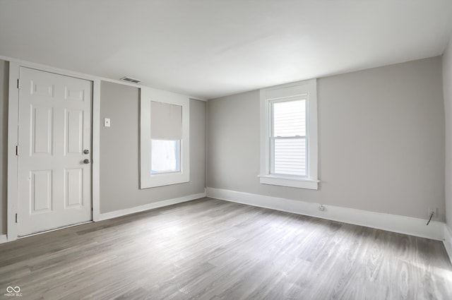 unfurnished room featuring baseboards and wood finished floors