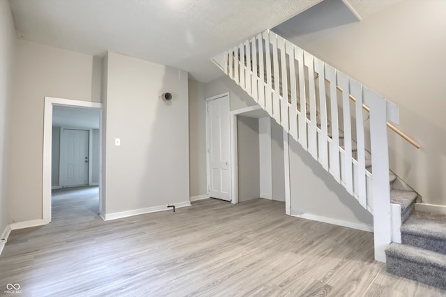 interior space with baseboards and wood finished floors