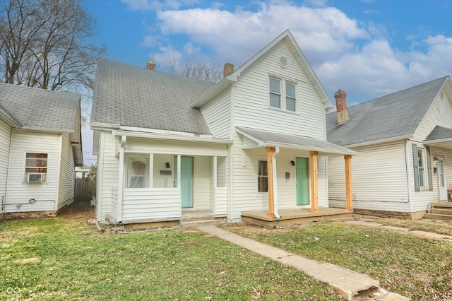 view of front facade featuring a porch, a front yard, and a shingled roof