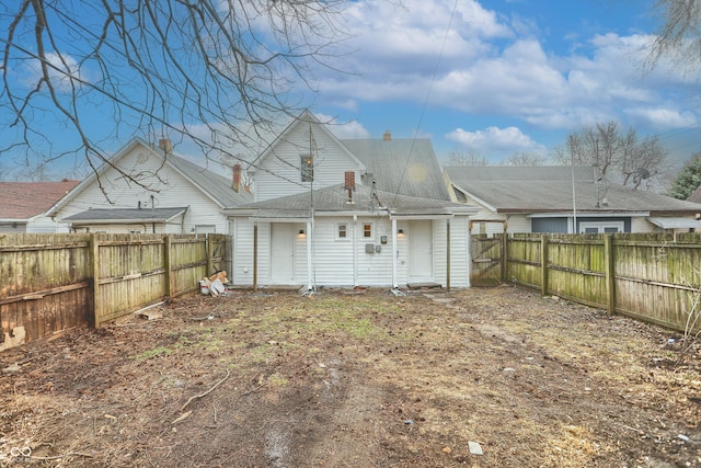 back of house with a fenced backyard