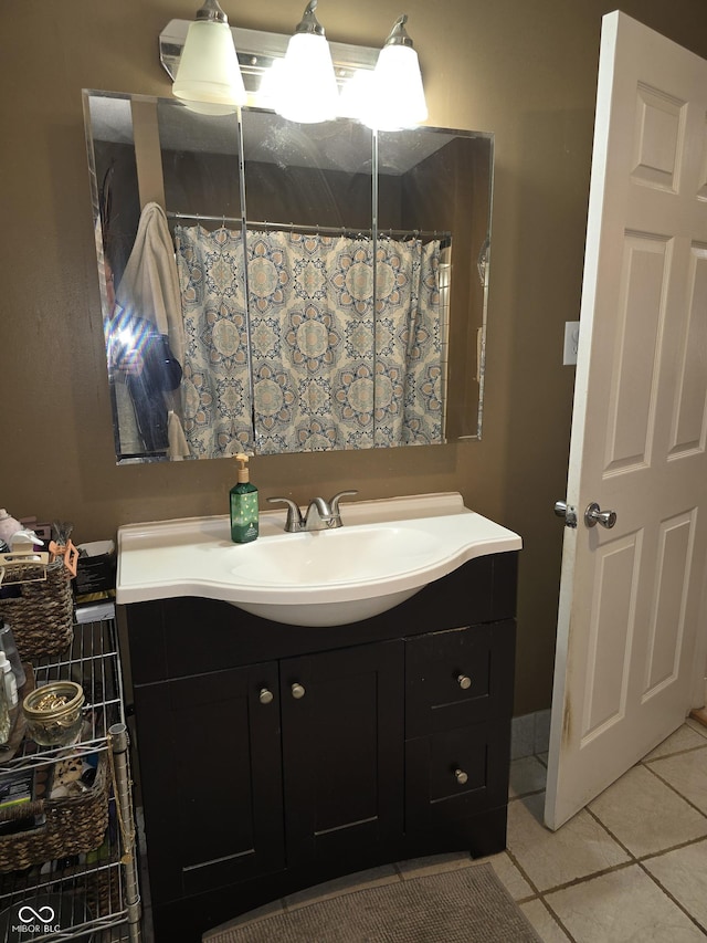 bathroom with a shower with shower curtain, vanity, and tile patterned floors