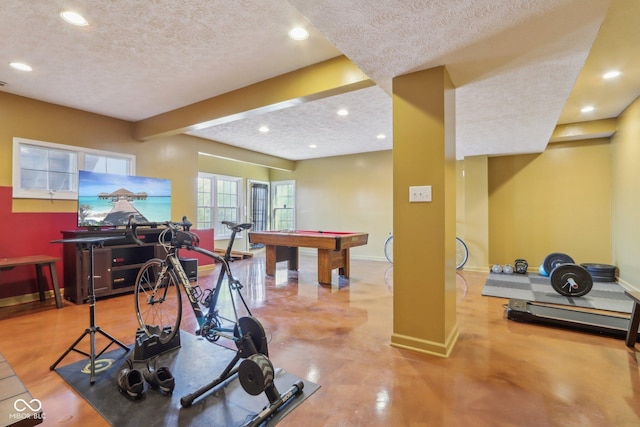 exercise area featuring recessed lighting, a textured ceiling, and baseboards