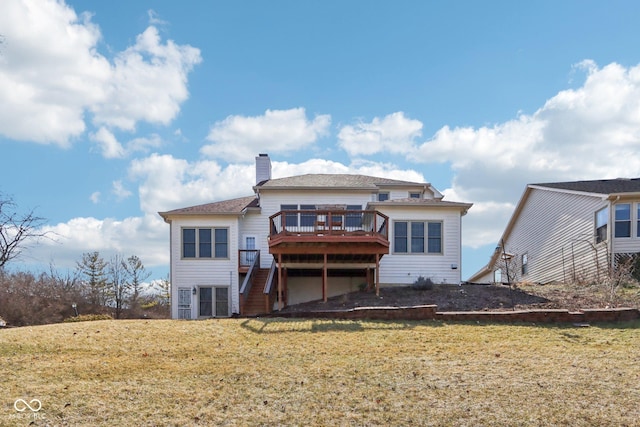 back of property featuring a chimney, a lawn, a wooden deck, and stairs