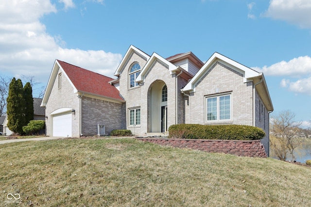 traditional home featuring a garage, brick siding, concrete driveway, and a front lawn