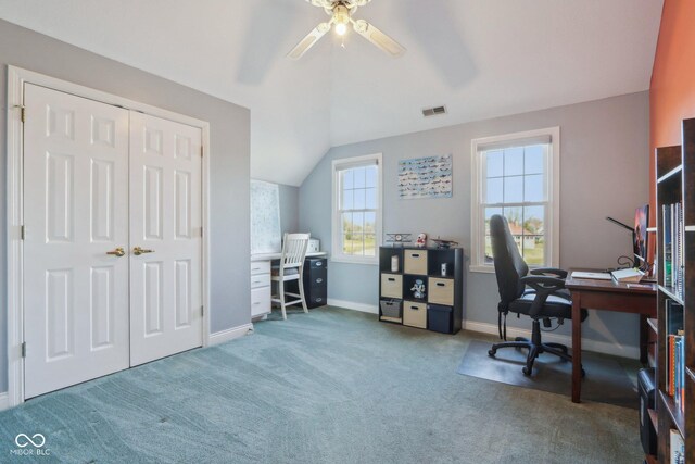 carpeted home office with visible vents, baseboards, a ceiling fan, and vaulted ceiling