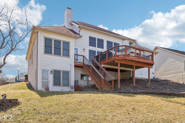 rear view of property with a yard, a chimney, a deck, and stairs