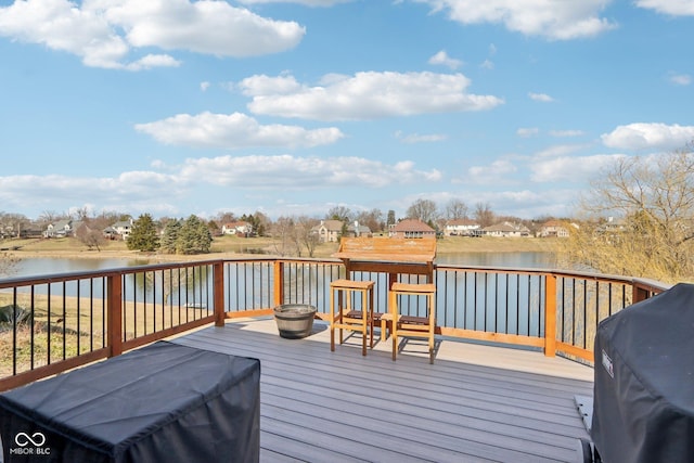 deck with a water view and a grill