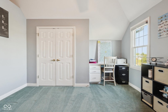 carpeted office space featuring baseboards and vaulted ceiling