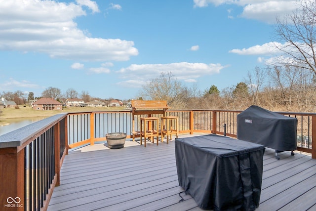 deck featuring a water view and a grill