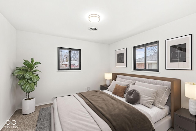 bedroom featuring visible vents, baseboards, and carpet