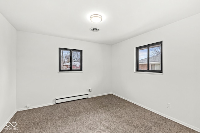 empty room featuring visible vents, baseboards, a baseboard heating unit, and carpet