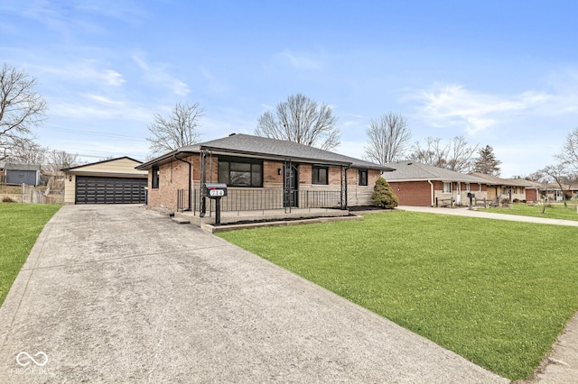 ranch-style home with brick siding, a detached garage, a front lawn, covered porch, and an outdoor structure