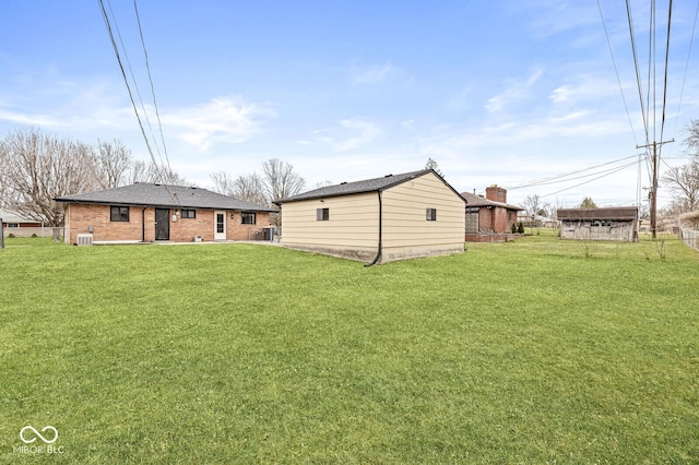 exterior space featuring a lawn and brick siding