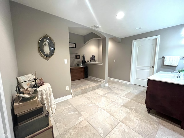 bathroom featuring recessed lighting, vanity, visible vents, and baseboards