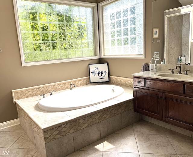 bathroom with tile patterned flooring, a garden tub, and vanity