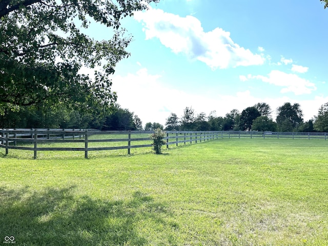 view of yard with a rural view and fence