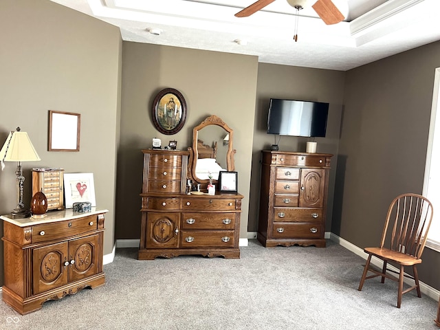 living area featuring carpet floors, ceiling fan, and baseboards