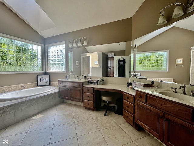 bathroom featuring lofted ceiling, a healthy amount of sunlight, and a sink