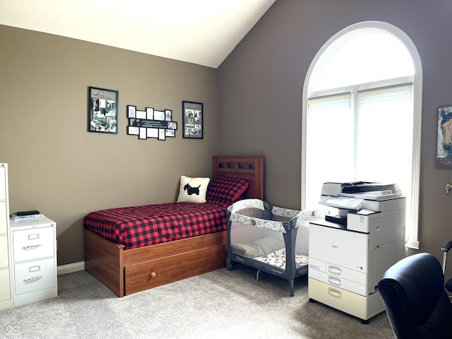 carpeted bedroom with lofted ceiling and arched walkways