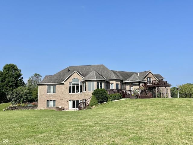 view of front of home with a front yard and a gazebo