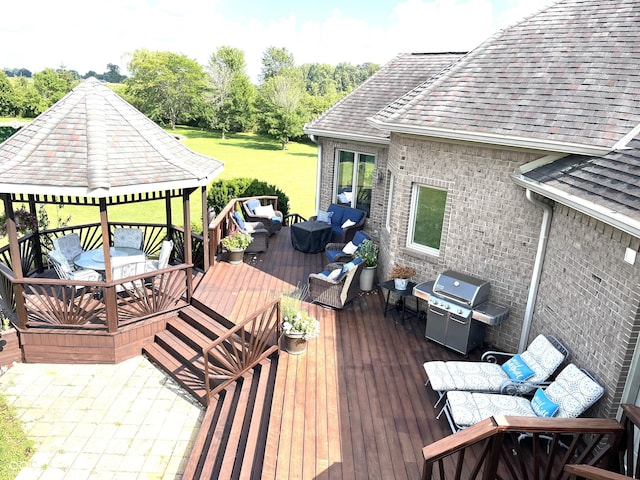 wooden terrace with grilling area, outdoor lounge area, and a gazebo