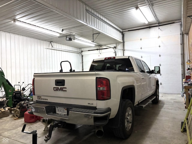 garage featuring metal wall and a garage door opener