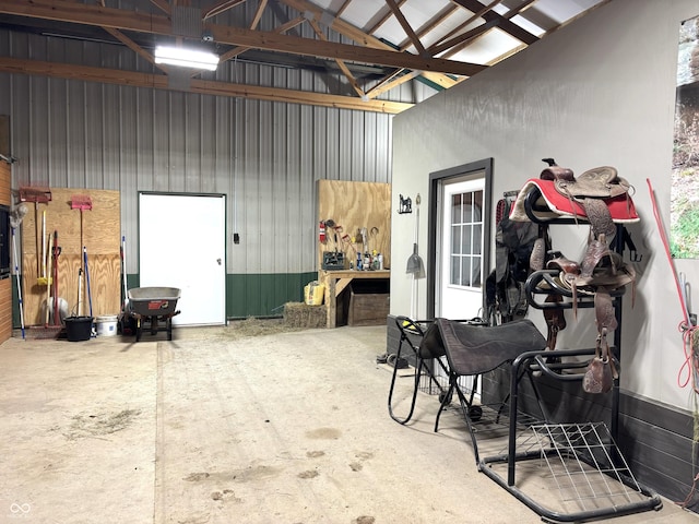 garage with a workshop area and metal wall