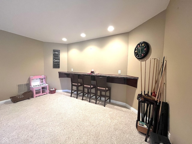 bar with recessed lighting, carpet floors, visible vents, baseboards, and a bar