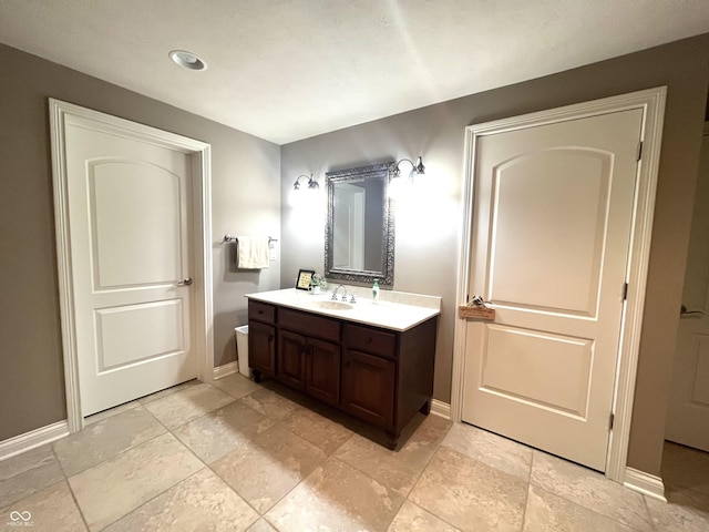 bathroom with vanity and baseboards