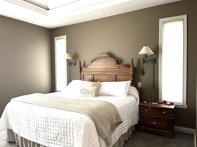 bedroom featuring carpet and baseboards