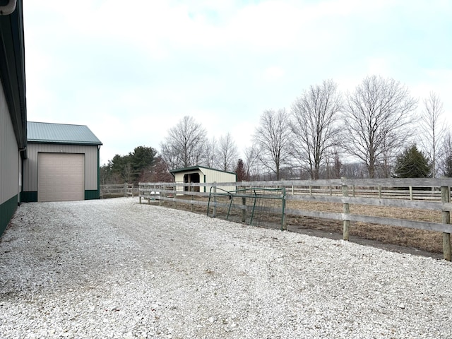 view of yard with fence, an outbuilding, and an outdoor structure