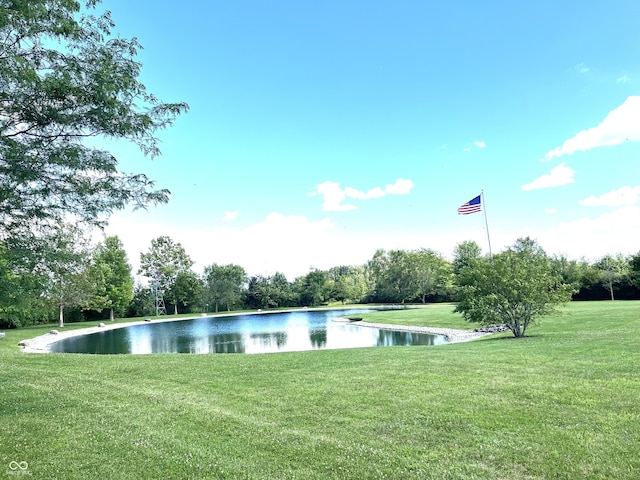 exterior space featuring a lawn and a water view