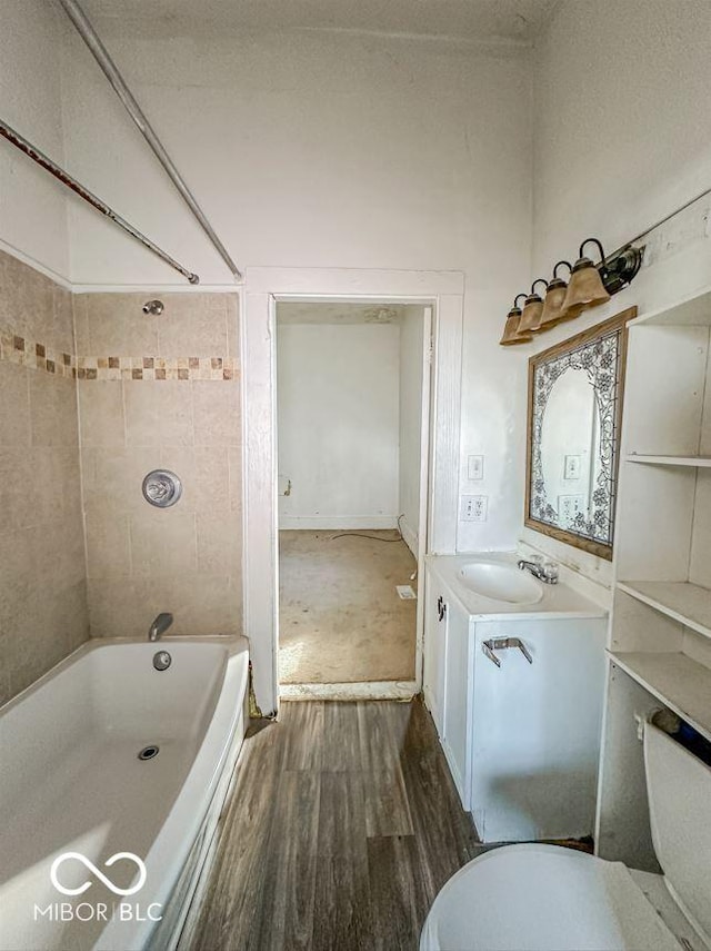 full bath with toilet, vanity, bathtub / shower combination, and wood finished floors