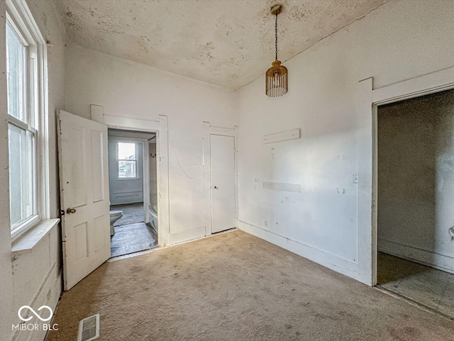 unfurnished room featuring visible vents and carpet